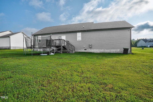 9448 S Beaver Creek Way, Middlesex, NC 27557 - back of property featuring a trampoline, a deck, a yard, and stairway