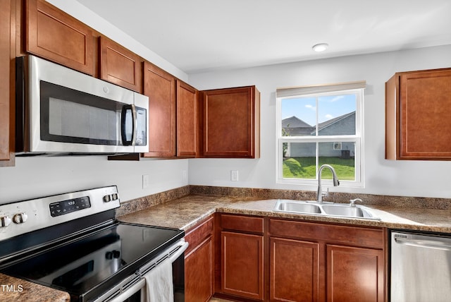 3 Windchime Ct, Durham, NC 27704 - kitchen featuring stainless steel appliances, dark countertops, and brown cabinetry