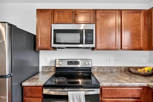 3 Windchime Ct, Durham, NC 27704 - kitchen featuring appliances with stainless steel finishes and brown cabinetry