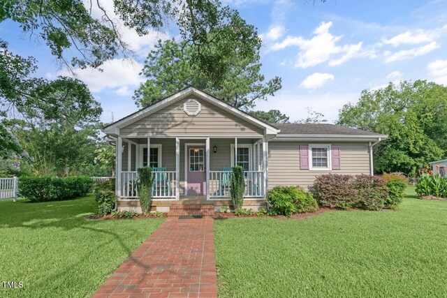 216 S Faison Ave, Faison, NC 28341 - view of front of property with covered porch, a front yard, and roof with shingles