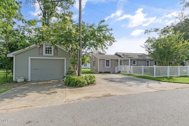 216 S Faison Ave, Faison, NC 28341 - view of front of home with a detached garage, an outdoor structure, and concrete driveway