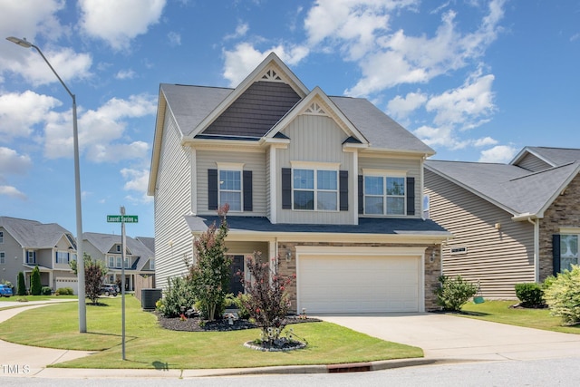 701 Laurel Spring Dr, Fuquay Varina, NC 27526 - craftsman-style house featuring driveway, a garage, board and batten siding, a front yard, and stone siding