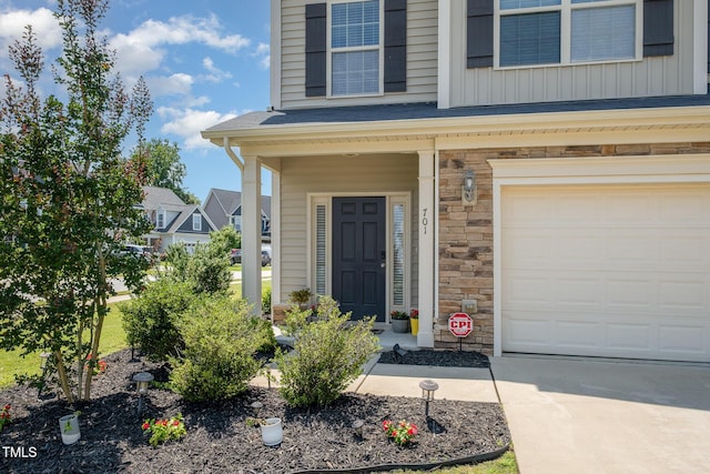701 Laurel Spring Dr, Fuquay Varina, NC 27526 - entrance to property featuring stone siding, a garage, and driveway
