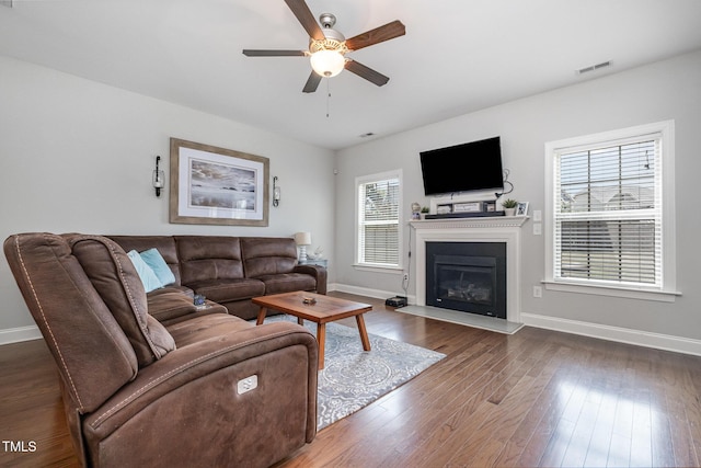 701 Laurel Spring Dr, Fuquay Varina, NC 27526 - living area with a ceiling fan, wood finished floors, and a glass covered fireplace