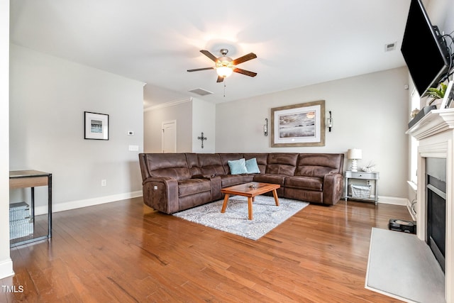 701 Laurel Spring Dr, Fuquay Varina, NC 27526 - living room featuring a fireplace, wood finished floors, ceiling fan, and crown molding