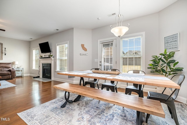 701 Laurel Spring Dr, Fuquay Varina, NC 27526 - dining room featuring wood finished floors and a fireplace with flush hearth
