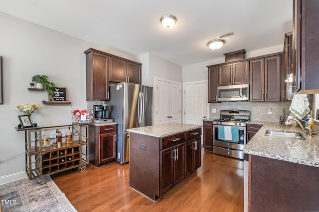 701 Laurel Spring Dr, Fuquay Varina, NC 27526 - kitchen with stainless steel appliances, dark wood-style flooring, and dark brown cabinetry