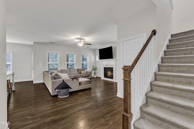 1725 River Club Way, Franklinton, NC 27525 - living room featuring ceiling fan, a warm lit fireplace, dark wood-style floors, and stairway