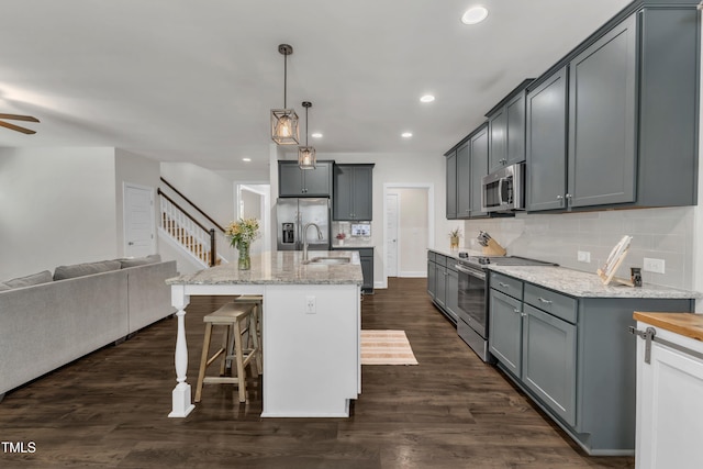 1725 River Club Way, Franklinton, NC 27525 - kitchen with stainless steel appliances, open floor plan, tasteful backsplash, recessed lighting, and light stone counters