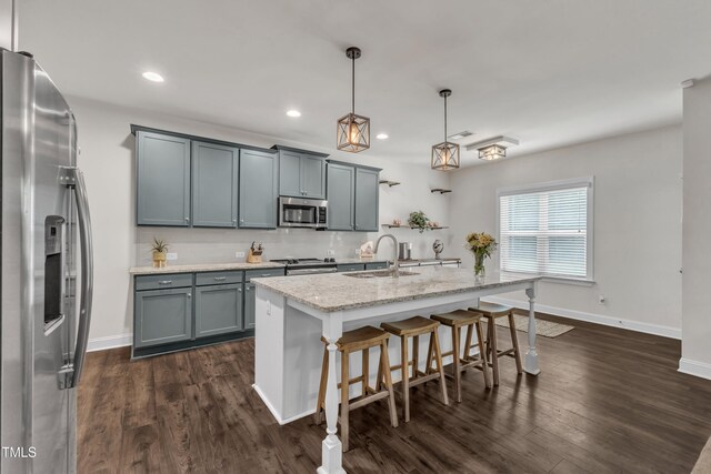 1725 River Club Way, Franklinton, NC 27525 - kitchen with appliances with stainless steel finishes, dark wood finished floors, a kitchen bar, light stone countertops, and hanging light fixtures
