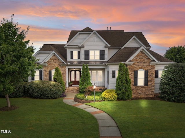 5005 Clyden Cv, Raleigh, NC 27612 - view of front of property with stone siding, a yard, and french doors