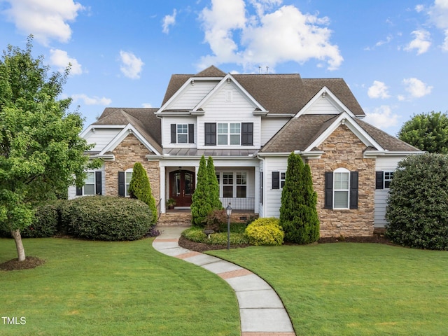 5005 Clyden Cv, Raleigh, NC 27612 - view of front of house with stone siding, roof with shingles, and a front lawn