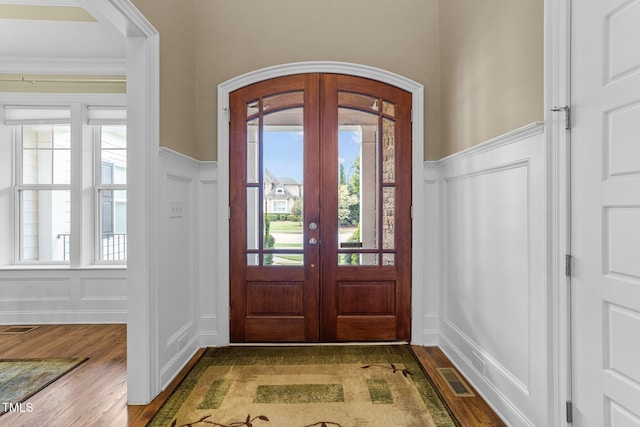 5005 Clyden Cv, Raleigh, NC 27612 - foyer entrance with a decorative wall, wood finished floors, wainscoting, and french doors