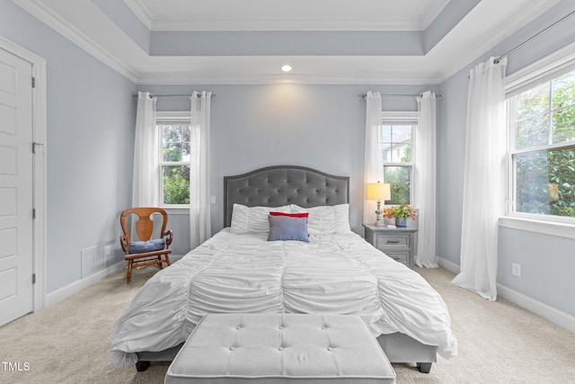 5005 Clyden Cv, Raleigh, NC 27612 - bedroom with multiple windows, carpet floors, a tray ceiling, and crown molding