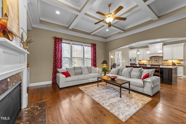 5005 Clyden Cv, Raleigh, NC 27612 - living room with a tiled fireplace, a ceiling fan, coffered ceiling, beamed ceiling, and crown molding