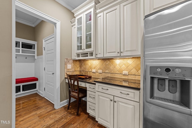 5005 Clyden Cv, Raleigh, NC 27612 - kitchen with stainless steel refrigerator with ice dispenser, crown molding, wood finished floors, glass insert cabinets, and backsplash