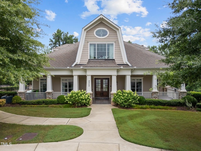5005 Clyden Cv, Raleigh, NC 27612 - craftsman-style house featuring french doors, covered porch, and a front yard