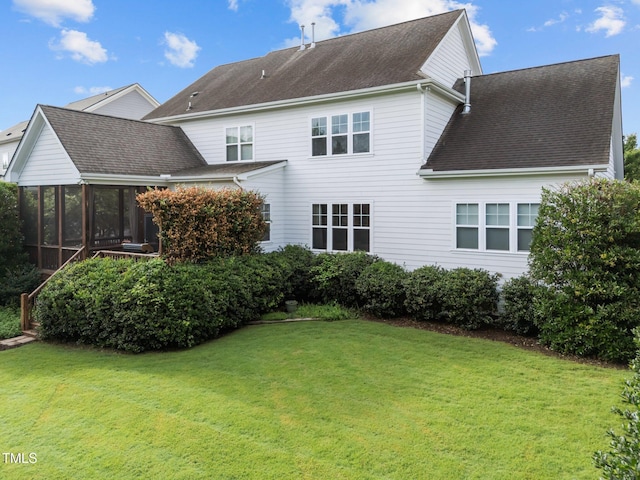 5005 Clyden Cv, Raleigh, NC 27612 - back of house featuring a sunroom, a lawn, and a shingled roof