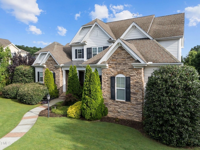 5005 Clyden Cv, Raleigh, NC 27612 - view of front of home featuring stone siding, a shingled roof, and a front lawn