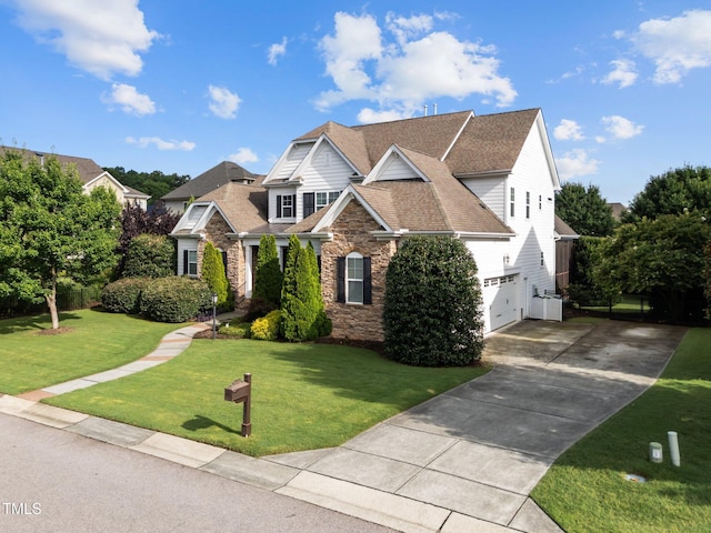 5005 Clyden Cv, Raleigh, NC 27612 - view of front of home featuring stone siding, concrete driveway, a front yard, a garage, and a shingled roof