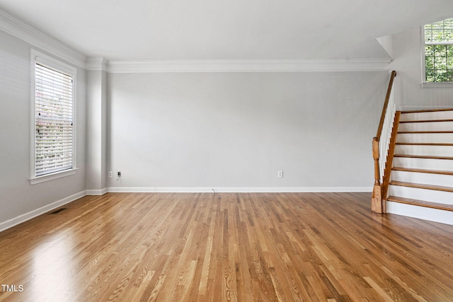 306 Kirkeenan Cir, Morrisville, NC 27560 - empty room featuring light wood-type flooring, stairs, and crown molding