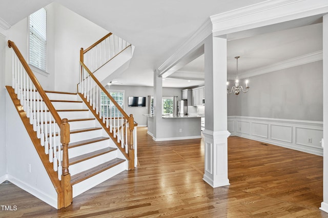 306 Kirkeenan Cir, Morrisville, NC 27560 - stairway featuring wood finished floors, ornamental molding, and a chandelier