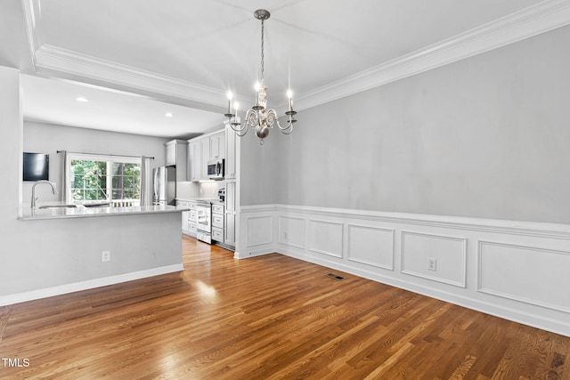 306 Kirkeenan Cir, Morrisville, NC 27560 - unfurnished dining area featuring a chandelier, crown molding, wood finished floors, wainscoting, and recessed lighting