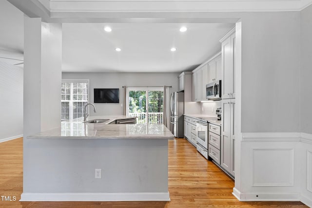 306 Kirkeenan Cir, Morrisville, NC 27560 - kitchen featuring stainless steel appliances, recessed lighting, light wood-style flooring, light stone countertops, and white cabinets