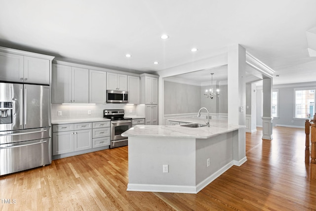 306 Kirkeenan Cir, Morrisville, NC 27560 - kitchen with appliances with stainless steel finishes, light wood-style floors, tasteful backsplash, light stone counters, and recessed lighting