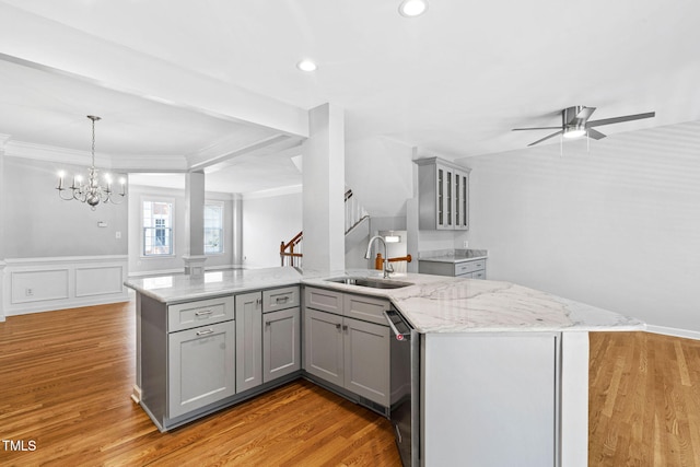 306 Kirkeenan Cir, Morrisville, NC 27560 - kitchen with gray cabinets, ornamental molding, light stone counters, a ceiling fan, and light wood-style flooring