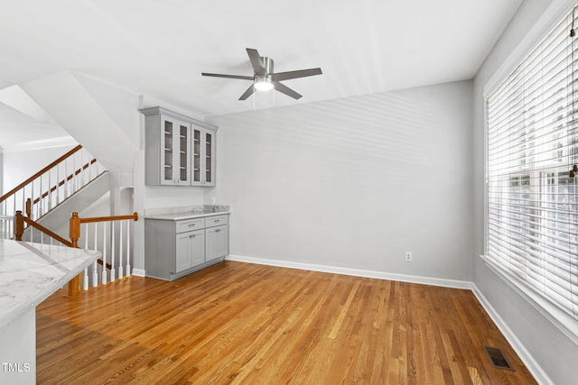 306 Kirkeenan Cir, Morrisville, NC 27560 - unfurnished living room featuring ceiling fan, light wood-style floors, and stairs