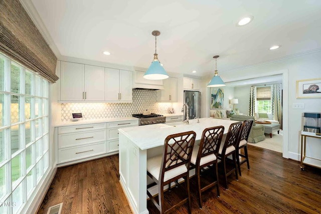 809 Blenheim Dr, Raleigh, NC 27612 - kitchen featuring stainless steel fridge with ice dispenser, light countertops, decorative backsplash, dark wood finished floors, and white cabinetry