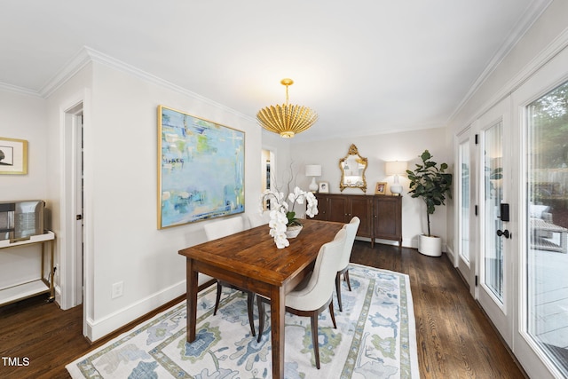809 Blenheim Dr, Raleigh, NC 27612 - dining room featuring a chandelier, dark wood-type flooring, and crown molding