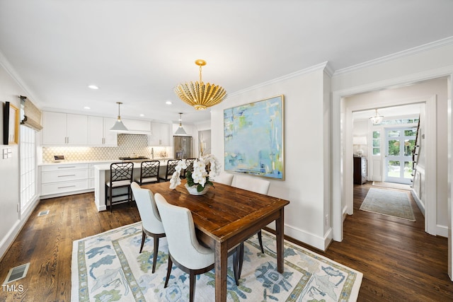 809 Blenheim Dr, Raleigh, NC 27612 - dining space with a chandelier, ornamental molding, dark wood-type flooring, and recessed lighting