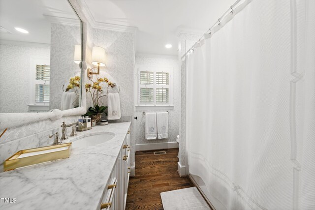 809 Blenheim Dr, Raleigh, NC 27612 - bathroom with crown molding, wood finished floors, vanity, wallpapered walls, and a shower with curtain