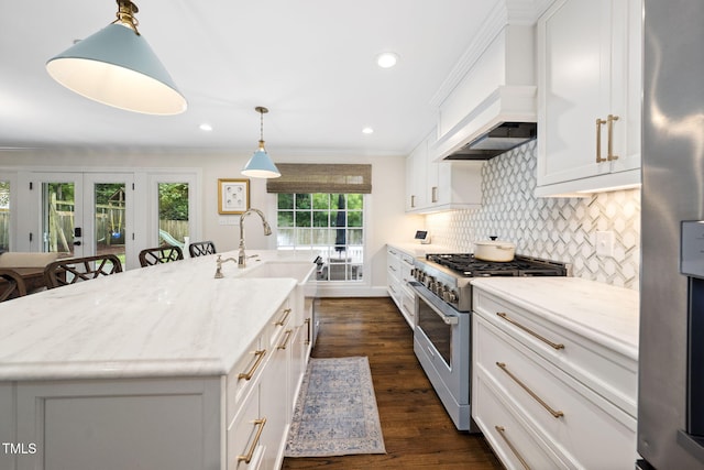 809 Blenheim Dr, Raleigh, NC 27612 - kitchen featuring appliances with stainless steel finishes, tasteful backsplash, dark wood-style flooring, light stone countertops, and white cabinets