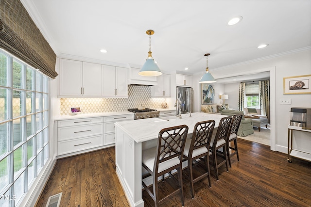 809 Blenheim Dr, Raleigh, NC 27612 - kitchen with stainless steel fridge, decorative backsplash, ornamental molding, dark wood-style flooring, and white cabinets