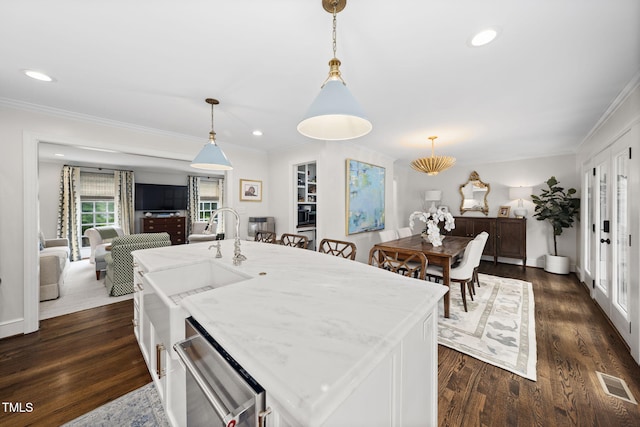 809 Blenheim Dr, Raleigh, NC 27612 - kitchen with dishwasher, crown molding, decorative light fixtures, dark wood-style flooring, and recessed lighting