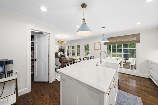 809 Blenheim Dr, Raleigh, NC 27612 - kitchen with ornamental molding, french doors, hanging light fixtures, light countertops, and dark wood finished floors