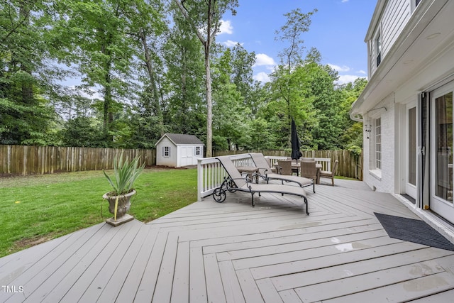 809 Blenheim Dr, Raleigh, NC 27612 - deck featuring outdoor dining space, a storage unit, a fenced backyard, and view of wooded area