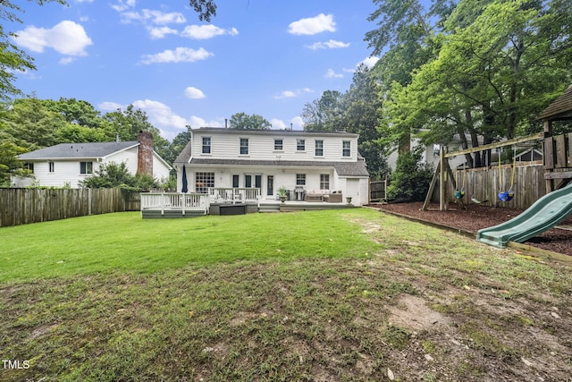 809 Blenheim Dr, Raleigh, NC 27612 - rear view of house with a playground, a fenced backyard, and a wooden deck