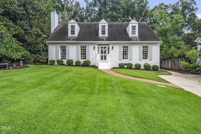 809 Blenheim Dr, Raleigh, NC 27612 - cape cod house with a chimney and brick siding