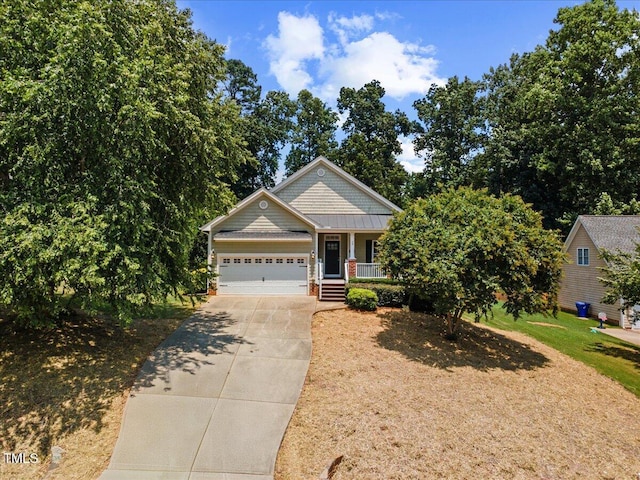 49 Brookridge Ct, Pittsboro, NC 27312 - view of front of property featuring a porch, driveway, and an attached garage
