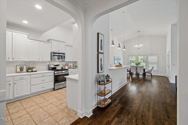 49 Brookridge Ct, Pittsboro, NC 27312 - kitchen featuring stainless steel appliances, light countertops, white cabinets, recessed lighting, and high vaulted ceiling