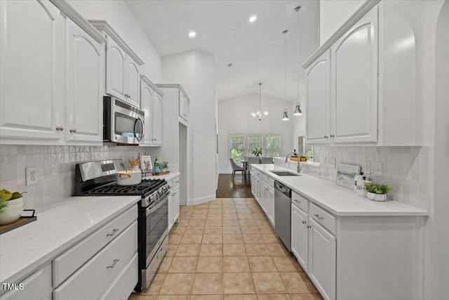 49 Brookridge Ct, Pittsboro, NC 27312 - kitchen featuring appliances with stainless steel finishes, white cabinetry, vaulted ceiling, tasteful backsplash, and recessed lighting