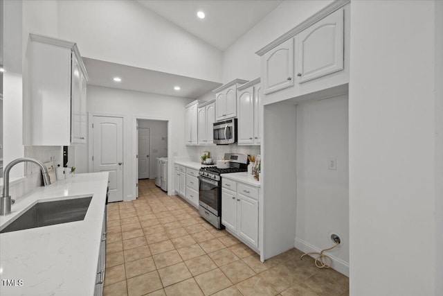 49 Brookridge Ct, Pittsboro, NC 27312 - kitchen featuring appliances with stainless steel finishes, backsplash, recessed lighting, light tile patterned flooring, and light stone countertops