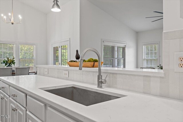 49 Brookridge Ct, Pittsboro, NC 27312 - kitchen with light stone counters, healthy amount of natural light, decorative light fixtures, a chandelier, and high vaulted ceiling