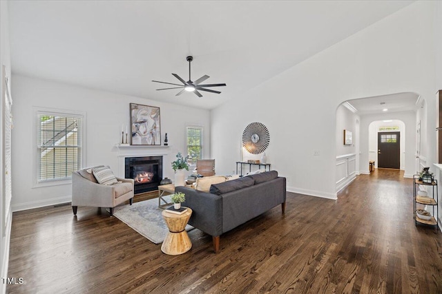 49 Brookridge Ct, Pittsboro, NC 27312 - living room with ceiling fan, dark wood-style floors, arched walkways, a glass covered fireplace, and vaulted ceiling