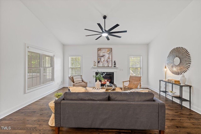 49 Brookridge Ct, Pittsboro, NC 27312 - living area with plenty of natural light, a warm lit fireplace, lofted ceiling, a ceiling fan, and dark wood-type flooring
