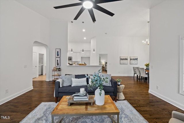 49 Brookridge Ct, Pittsboro, NC 27312 - living area with a ceiling fan, a towering ceiling, a chandelier, dark wood-type flooring, and arched walkways